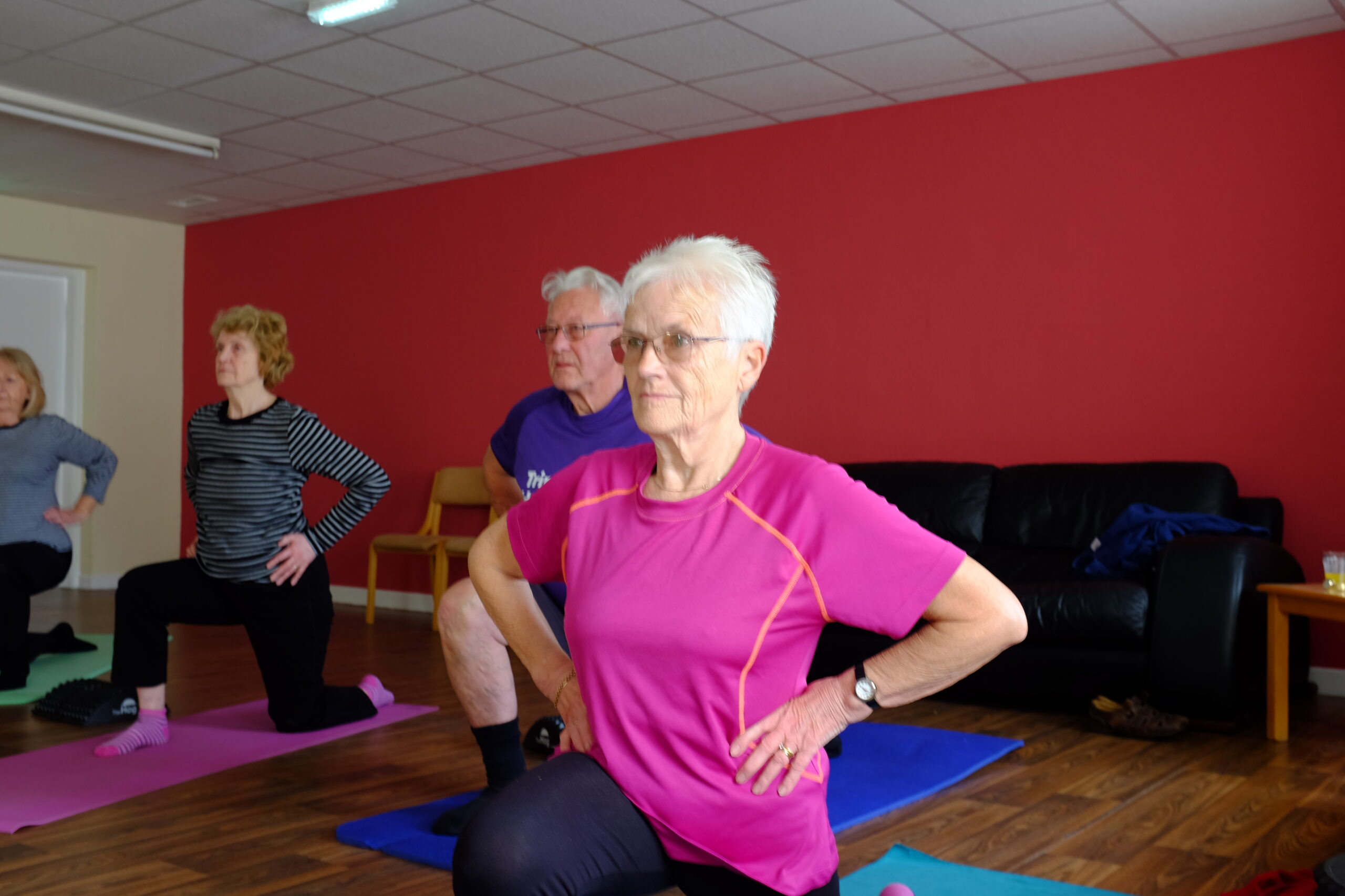 Older woman partaking in a yoga class.