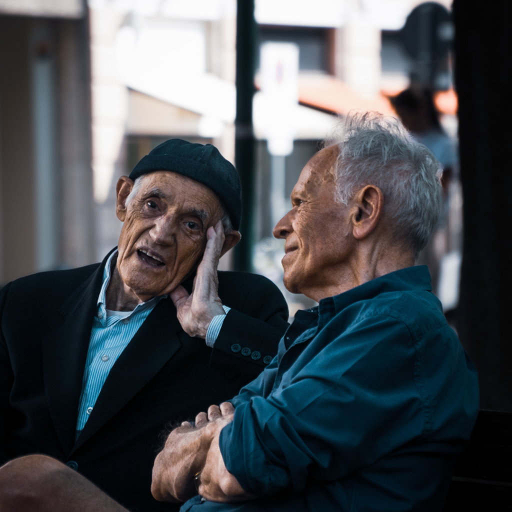 Two elderly gentleman talking with each other